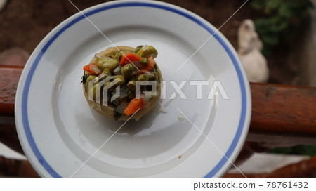 Healthy food Artichoke on the white plate. Close-up Artichoke food with beans, peas, onions and carrots. Delicious healthy vegan food with olive oil. 78761432