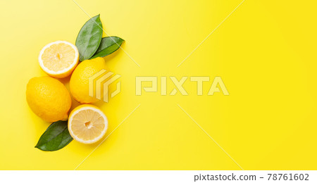 Fresh ripe lemon on yellow background Fresh ripe lemon on yellow background 78761602