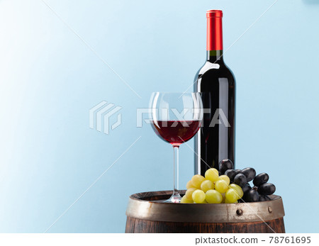 Wine bottle with red wine and old wooden barrel Wine bottle with red wine and old wooden barrel 78761695