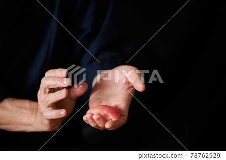 Sushi craftsman holding sushi 78762929