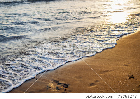 soft sea waves with a foam breaking on a sandy shore tropical beach at summer at sunset soft sea waves with a foam breaking on a sandy shore tropical beach at summer at sunset 78763278