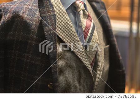 Close-up of a man's bust in a tie and checkered winter suit Close-up of a man's bust in a tie and checkered winter suit 78763585