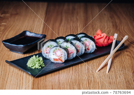 Sushi on a Wooden Table in Restaurant, Delicious Japanese Food, Sushi Rolls Sushi on a Wooden Table in Restaurant, Delicious Japanese Food, Sushi Rolls 78763694