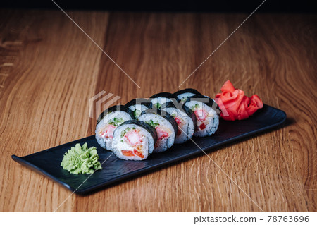 Sushi on a Wooden Table in Restaurant, Delicious Japanese Food, Sushi Rolls Sushi on a Wooden Table in Restaurant, Delicious Japanese Food, Sushi Rolls 78763696