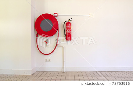 Fire hose on a wall 78763916