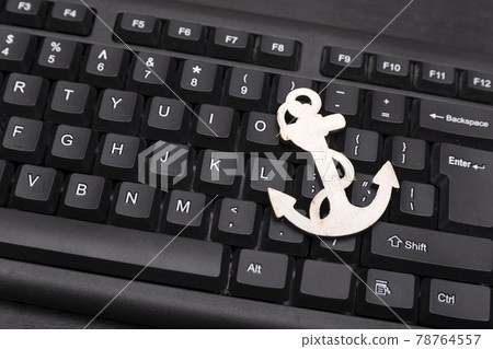 Black computer keyboard and anchor. Close up Black computer keyboard and anchor. Close up 78764557