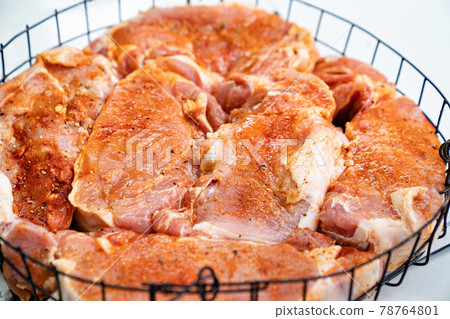 raw marinated meat in spices in a special baking dish in tandoor or grilled.  78764801