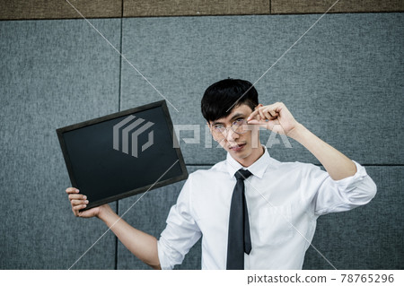 Back to school. Asian male student wearing holding a blackboard for Text messages College male Back to School after Pandemic Coronavirus Disease 2019 Back to school. Asian male student wearing holding a blackboard for Text messages College male Back to School after Pandemic Coronavirus Disease 2019 78765296