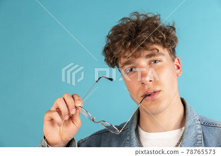 Young male portrait isolated on studio background with copyspace for ad. 78765573
