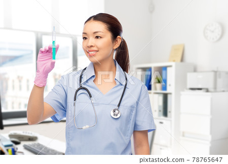 happy asian female nurse with syringe at hospital happy asian female nurse with syringe at hospital 78765647