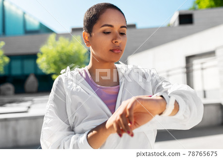 young woman with smart watch outdoors young woman with smart watch outdoors 78765675