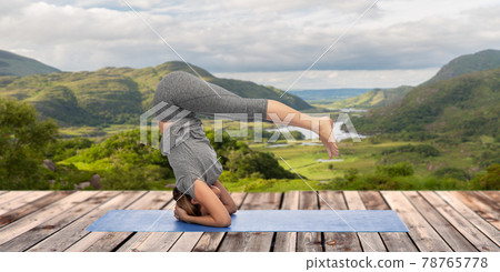 woman doing yoga over Killarney National Park woman doing yoga over Killarney National Park 78765778