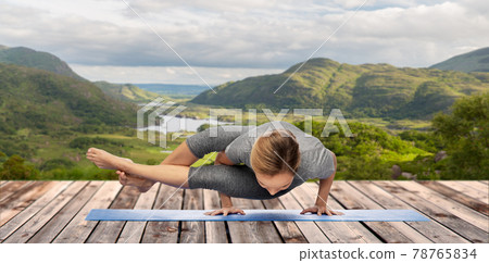 woman doing yoga over Killarney National Park 78765834