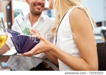 close up of couple with money paying at restaurant 78765835