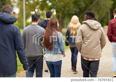 happy friends walking along autumn park happy friends walking along autumn park 78765921