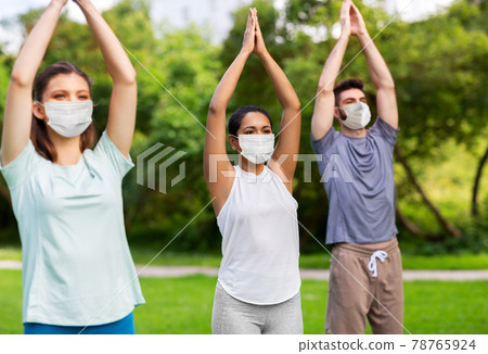 group of people doing yoga at summer park group of people doing yoga at summer park 78765924
