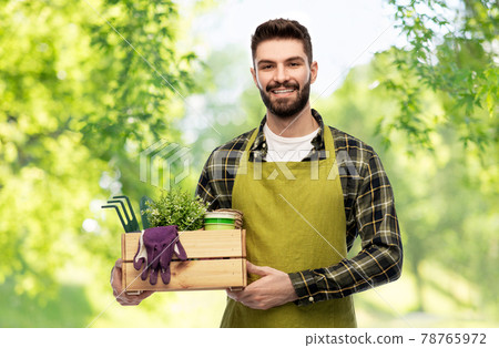 happy gardener or farmer with box of garden tools happy gardener or farmer with box of garden tools 78765972
