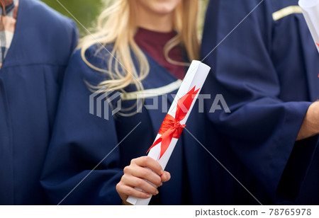 graduate students in mortar boards with diplomas graduate students in mortar boards with diplomas 78765978