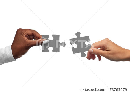 black and white hands matching pieces of puzzle black and white hands matching pieces of puzzle 78765979