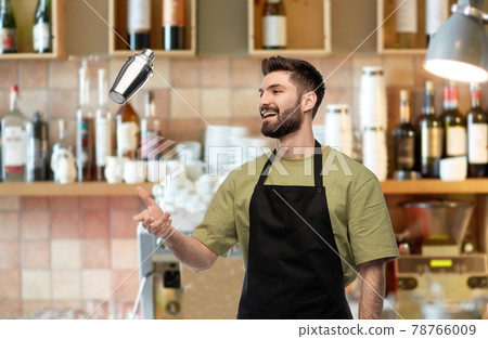 happy barman with shaker preparing drink at bar 78766009