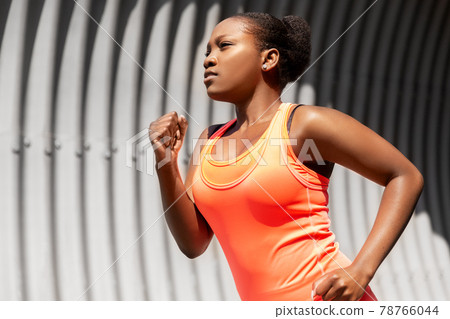 young african american woman running in tunnel 78766044