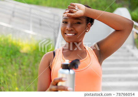 tired african american woman with bottle of water tired african american woman with bottle of water 78766054