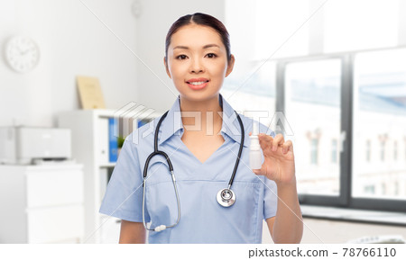 smiling asian female doctor or nurse with medicine 78766110