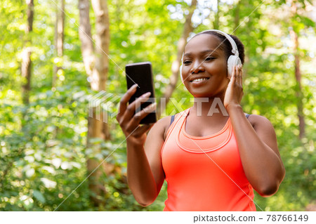 african american woman with headphones and phone african american woman with headphones and phone 78766149