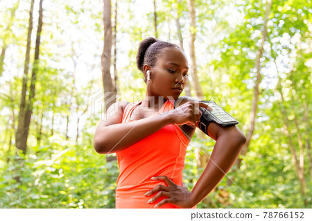 african american woman with earphones and phone african american woman with earphones and phone 78766152