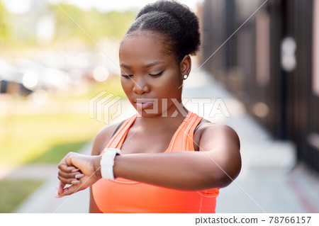 african woman with smart watch doing sports african woman with smart watch doing sports 78766157