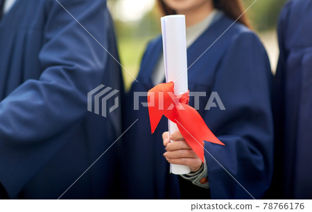 graduate students in mortar boards with diplomas graduate students in mortar boards with diplomas 78766176