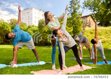 group of people doing yoga with instructor at park group of people doing yoga with instructor at park 78766453