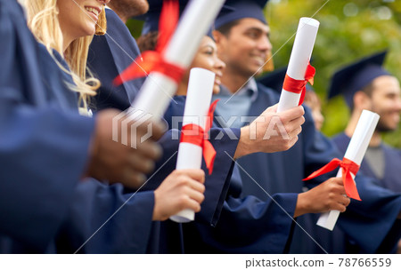 graduate students in mortar boards with diplomas graduate students in mortar boards with diplomas 78766559