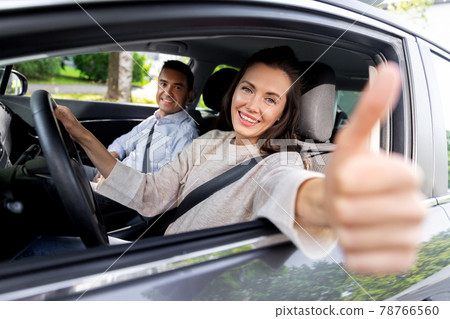 car driving instructor and woman showing thumbs up car driving instructor and woman showing thumbs up 78766560