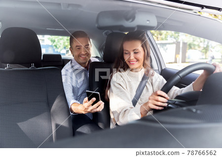 female driver driving car with male passenger female driver driving car with male passenger 78766562