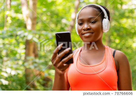african american woman with headphones and phone african american woman with headphones and phone 78766606