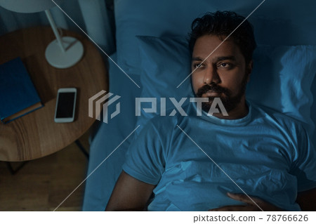 speelpess indian man lying in bed at night speelpess indian man lying in bed at night 78766626
