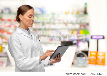 female doctor with tablet computer at pharmacy female doctor with tablet computer at pharmacy 78766670