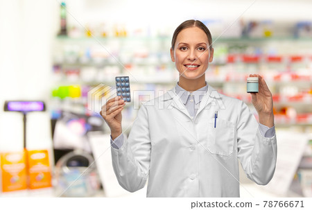smiling female doctor holding medicine at pharmacy smiling female doctor holding medicine at pharmacy 78766671