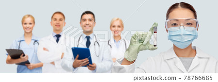 asian female doctor holding beaker with blood test 78766685