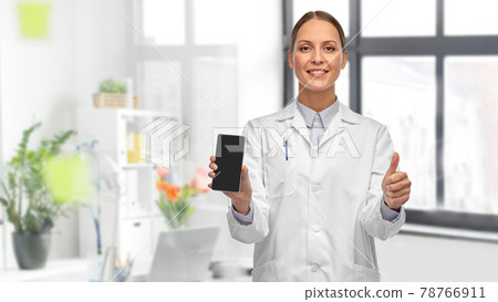 female doctor with smartphone showing thumbs up 78766911