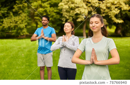 group of people doing yoga at summer park group of people doing yoga at summer park 78766940