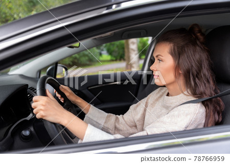 woman or female driver driving car in city woman or female driver driving car in city 78766959