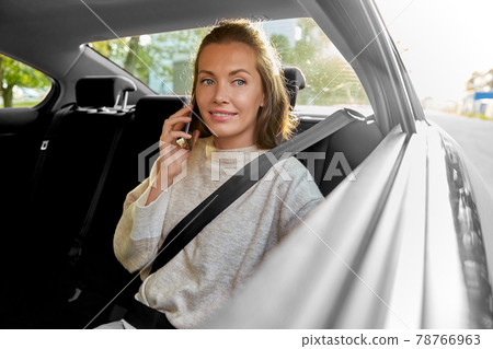 happy smiling woman in car calling on smartphone happy smiling woman in car calling on smartphone 78766963