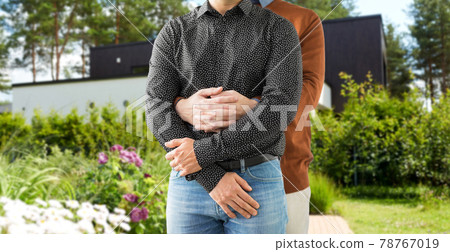 close up of hugging male gay couple at garden close up of hugging male gay couple at garden 78767019