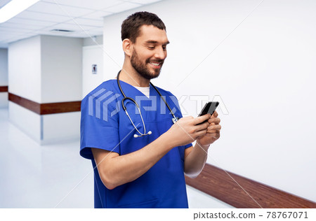 smiling doctor or male nurse using smartphone smiling doctor or male nurse using smartphone 78767071