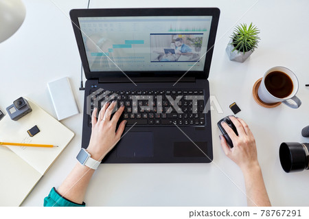 woman with video editor program on laptop at home woman with video editor program on laptop at home 78767291
