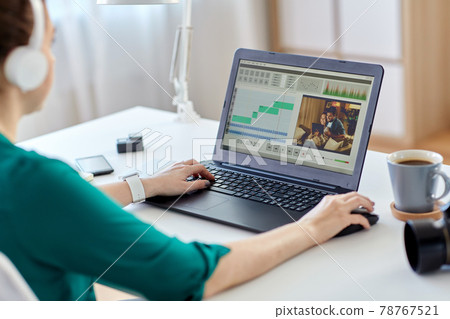 woman with video editor program on laptop at home 78767521