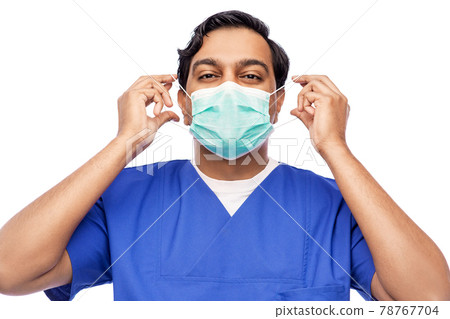 indian male doctor in blue uniform putting mask on 78767704