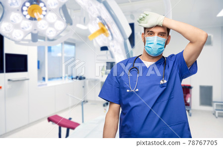 tired male doctor in blue uniform, mask and gloves tired male doctor in blue uniform, mask and gloves 78767705